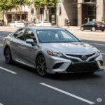 Front and side view of Toyota's updated entry-level sedan with redesigned grille and LED headlights.